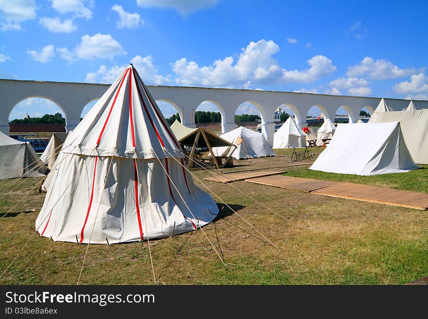 White tents near ancient wall