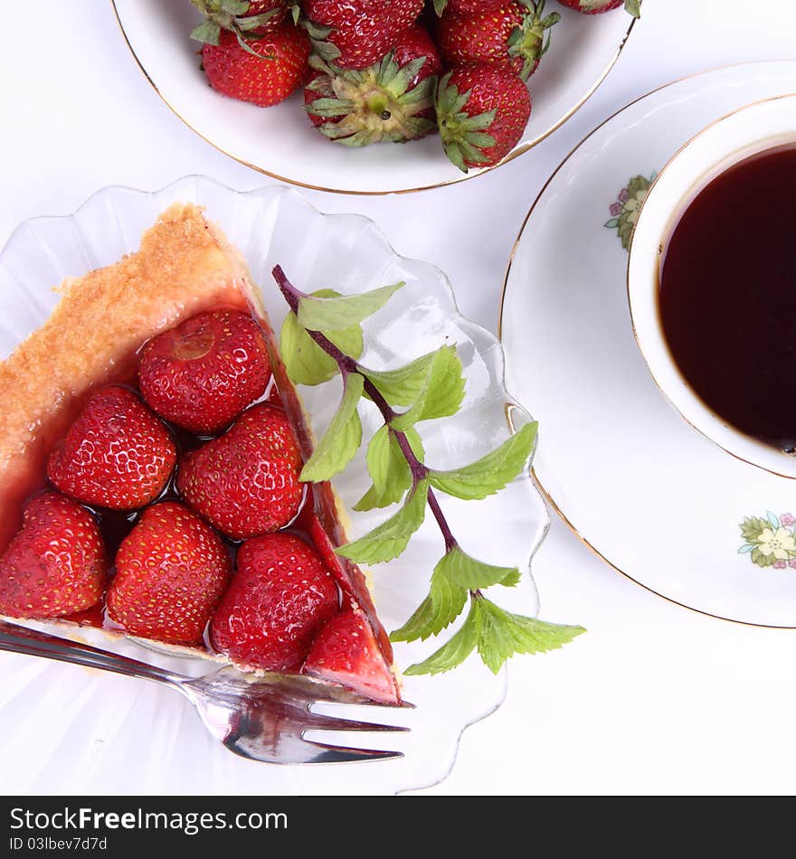 Strawberry tart, fruits and a cup of tea