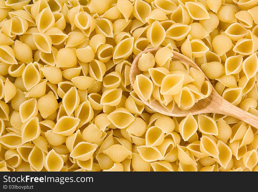 Pasta and wooden spoon as background