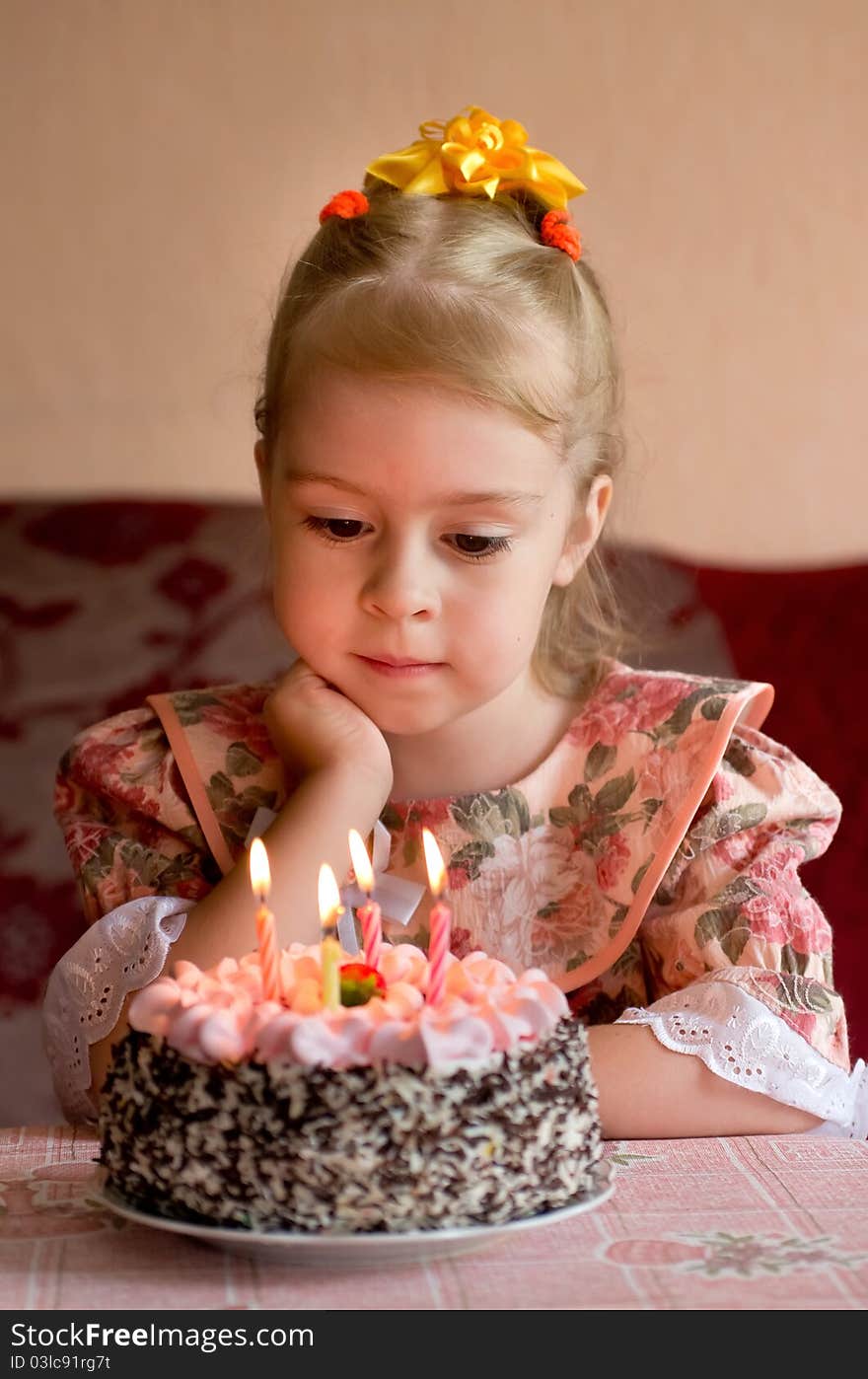 The little girl make a wish before you blow out the candles. The little girl make a wish before you blow out the candles