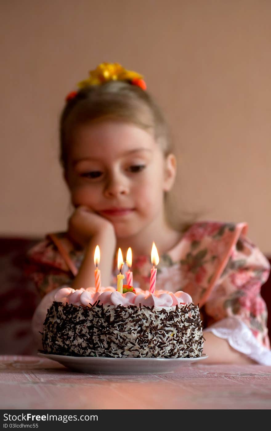 The little girl make a wish before you blow out the candles. The little girl make a wish before you blow out the candles