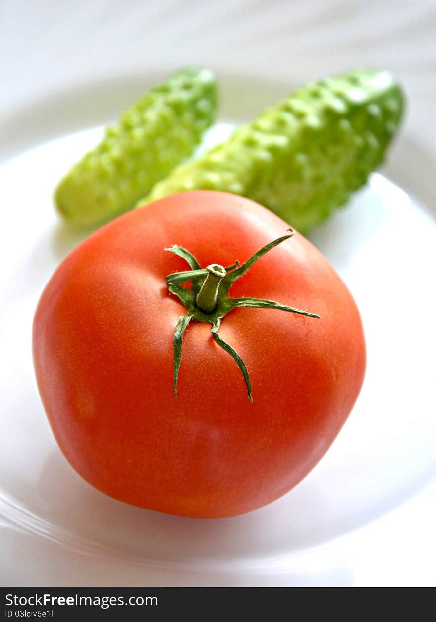 Tomato and cucumbers on plate