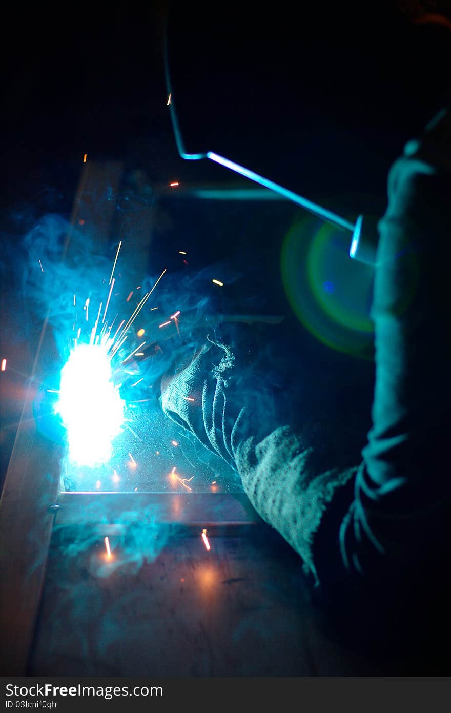 Photo of the welding process with sparks flying around. Photo of the welding process with sparks flying around