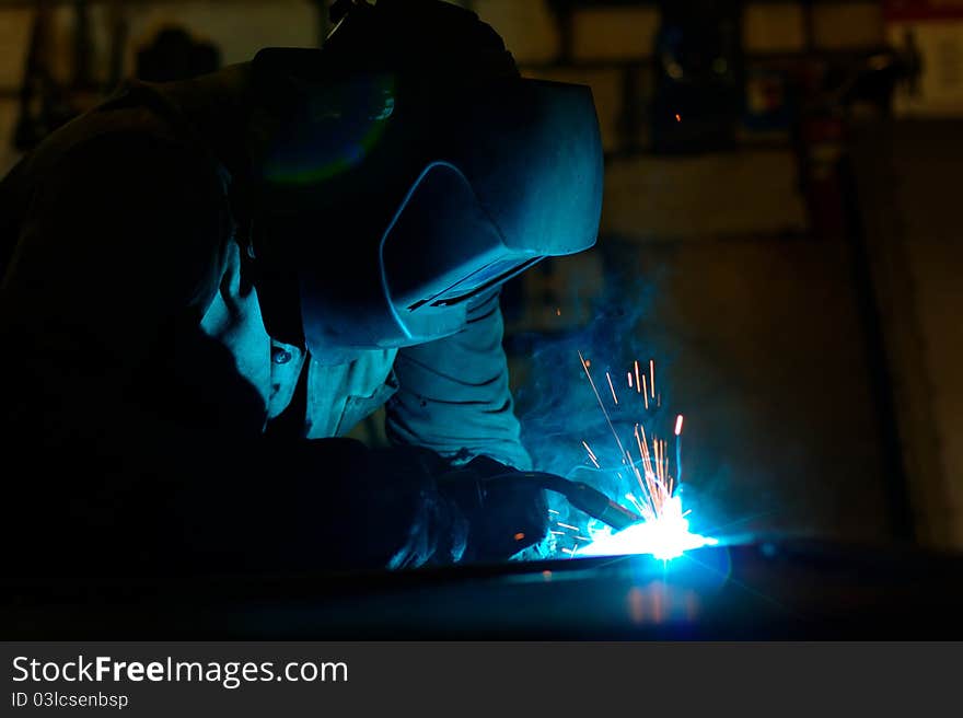 Photo of the welding process with sparks flying around. Photo of the welding process with sparks flying around