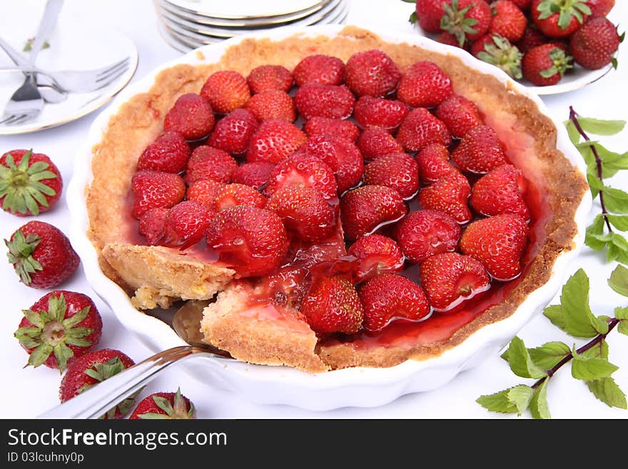 Strawberry Tart, with portion being served, on white background