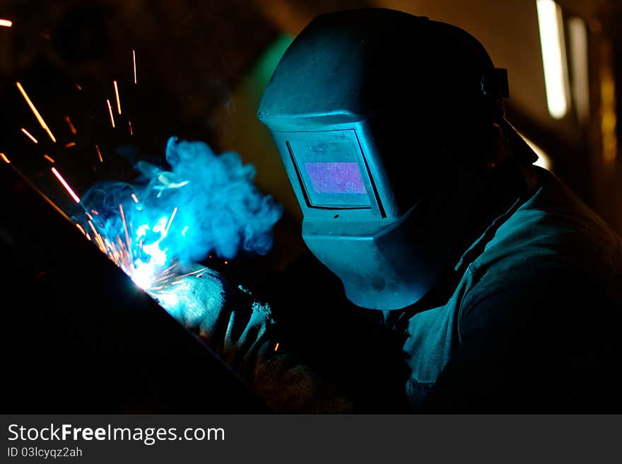 Photo of the welding process with sparks flying around. Photo of the welding process with sparks flying around