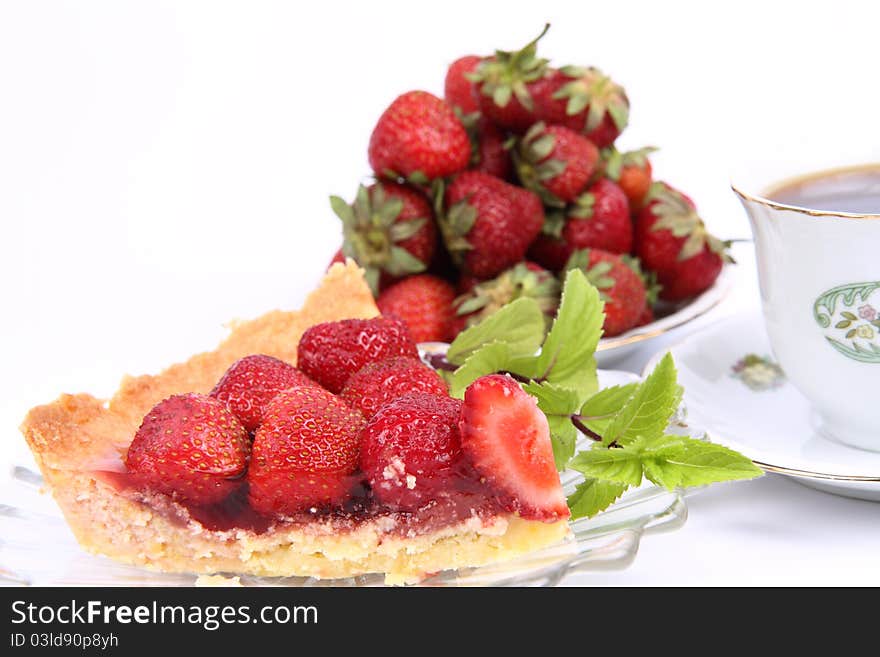 Strawberry Tart portion decorated with  mint twig and some strawberries