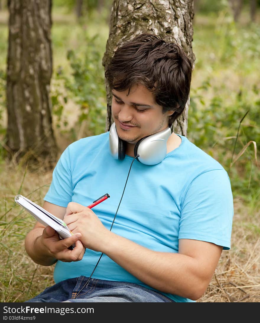 Student with notebook and headphones.