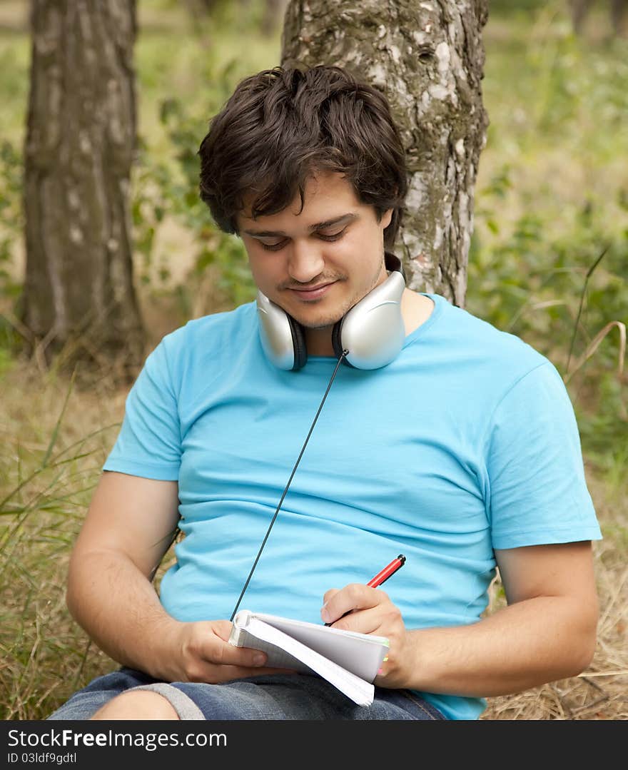 Student with notebook and headphones.