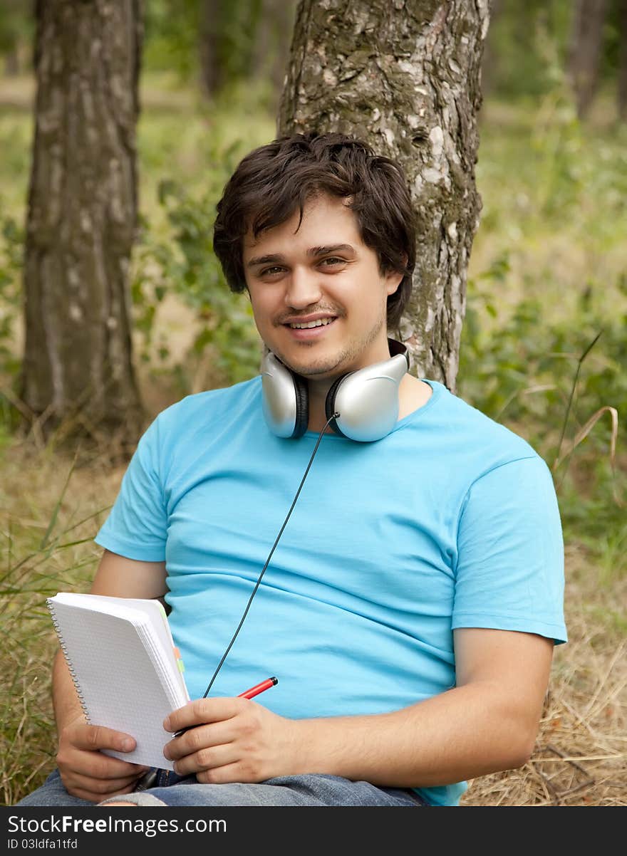 Student with notebook and headphones.