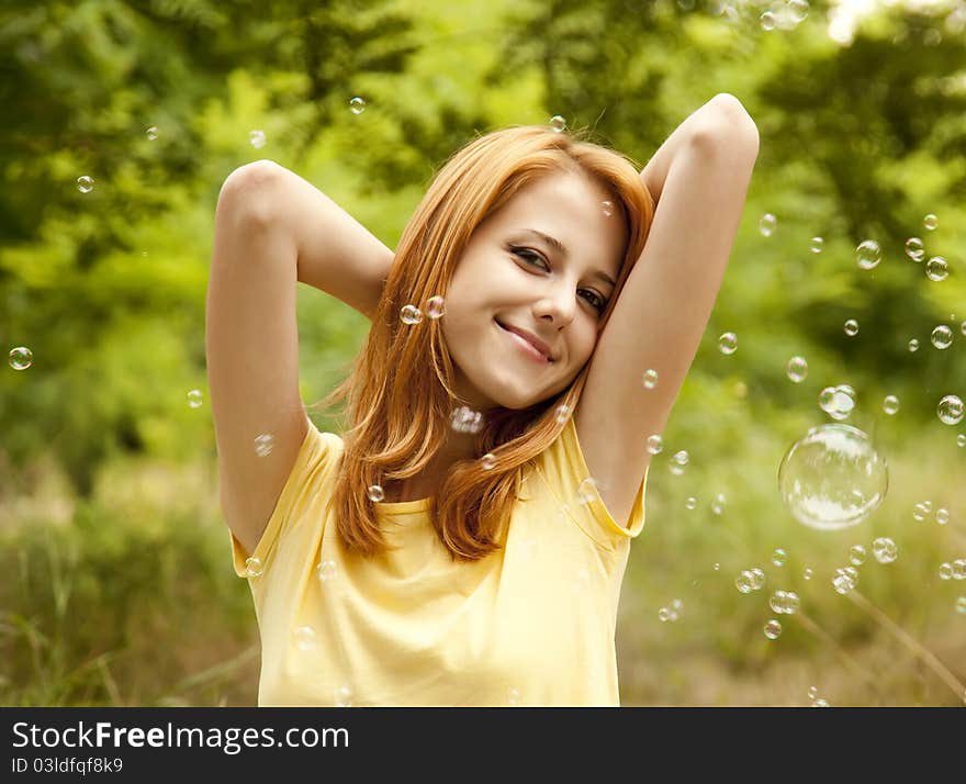 Girl In The Park Under Soap Bubble Rain.