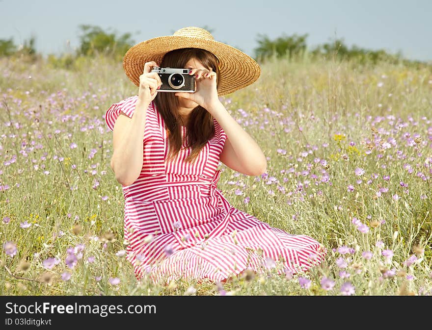 Retro style girl at countryside with camera