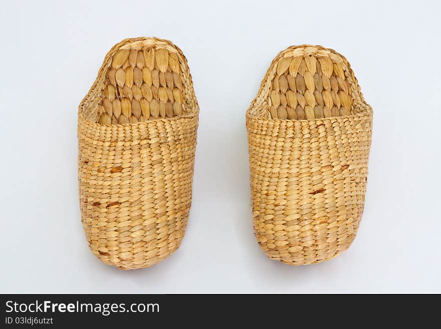 Handmade slippers from dry water hyacinth on white background