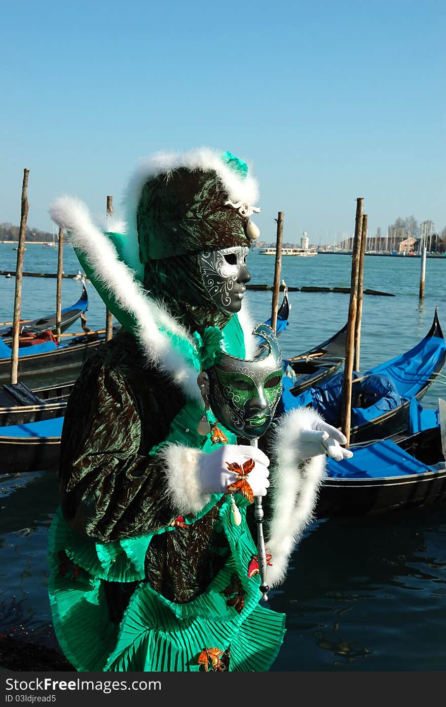 Green mask at Venice embankment during carnival 2011. Green mask at Venice embankment during carnival 2011