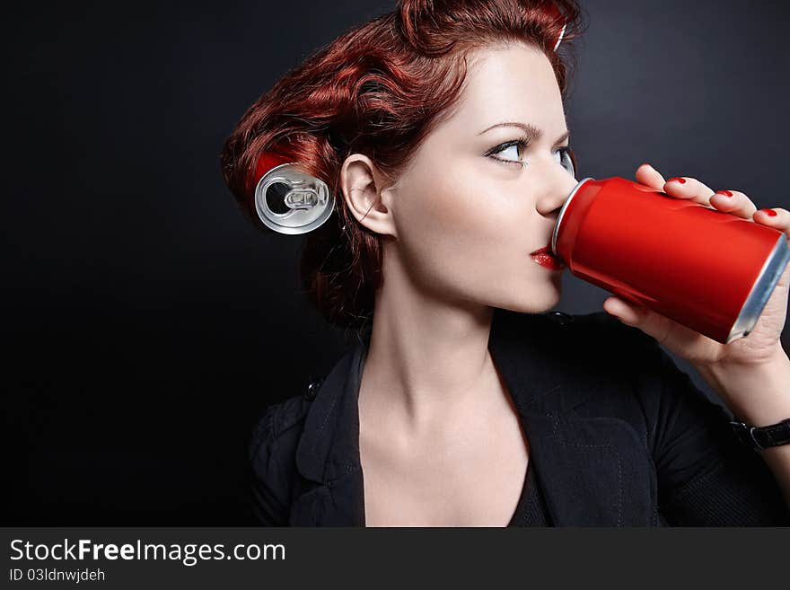 Young girl drinking from a can. Young girl drinking from a can