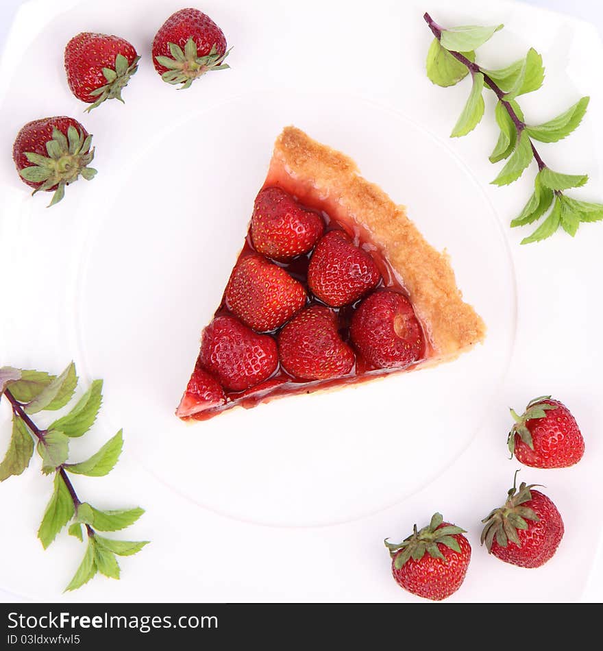 Piece of Strawberry Tart decorated with strawberries and mint