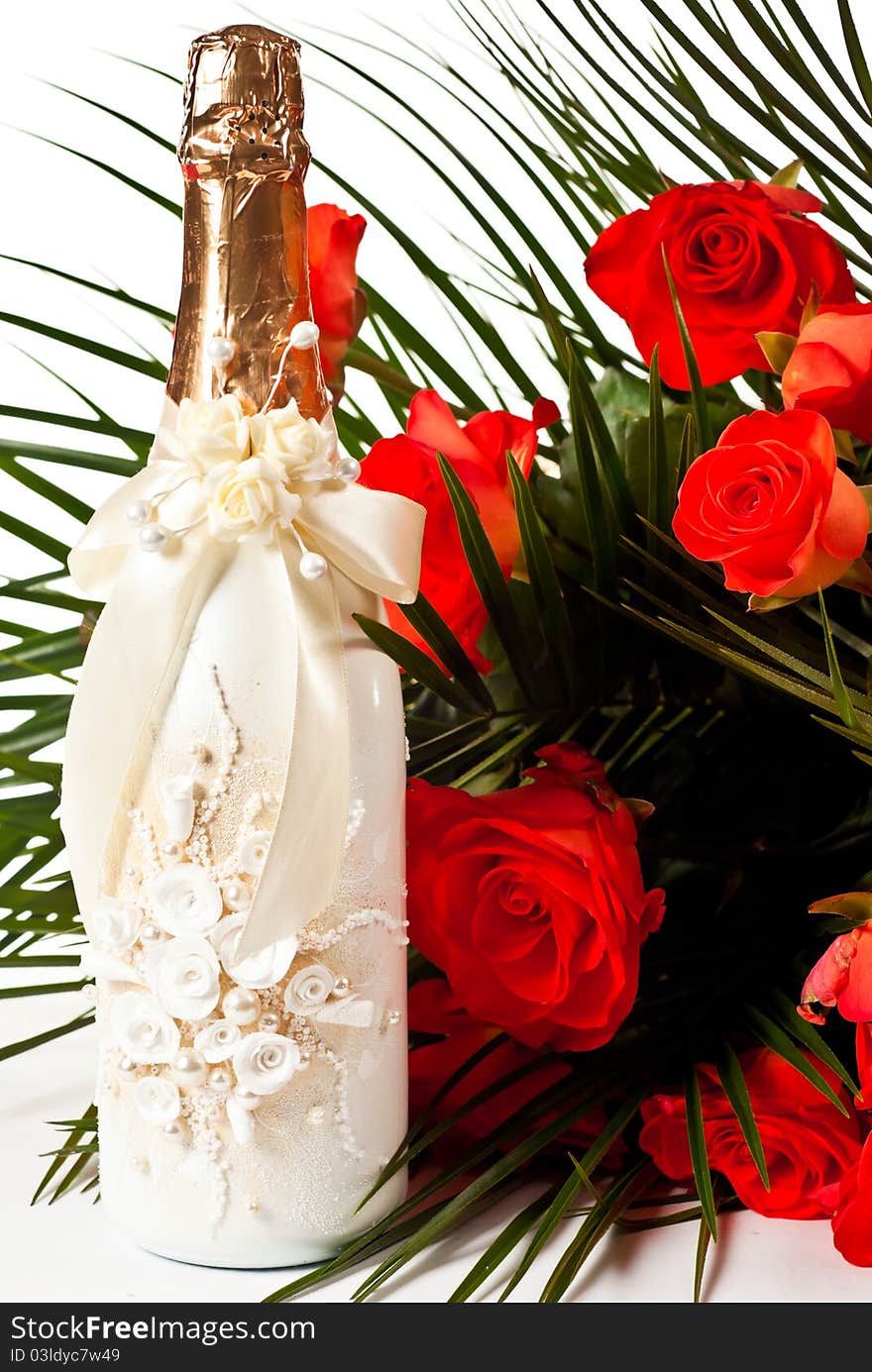 Red roses and champagne on white background