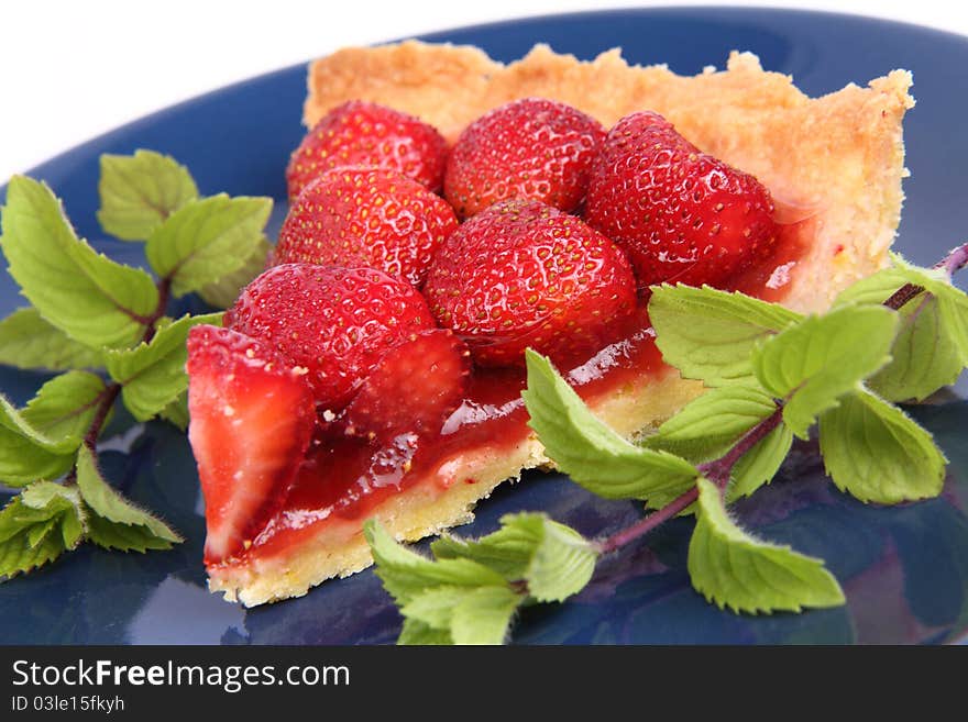 Strawberry Tart portion decorated with mint twigs