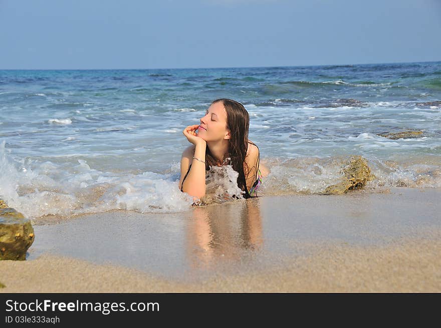 Girl lying in the sea waves