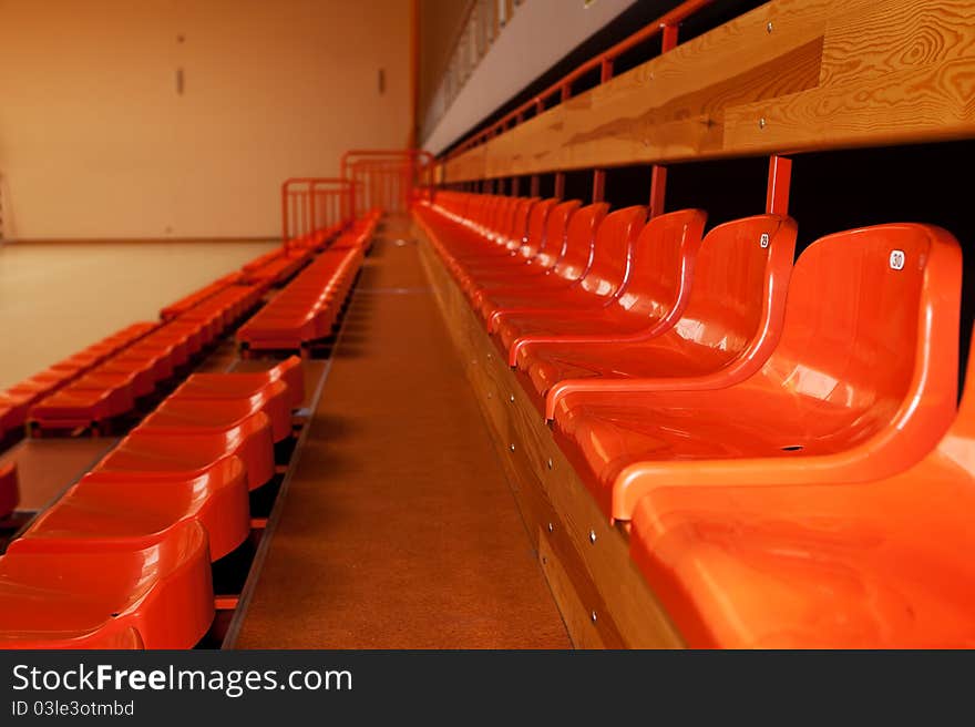 Orange, Plastic Seats In Rows.