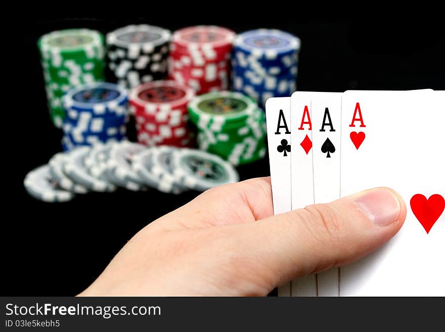 Cards and ultimate poker chips on black