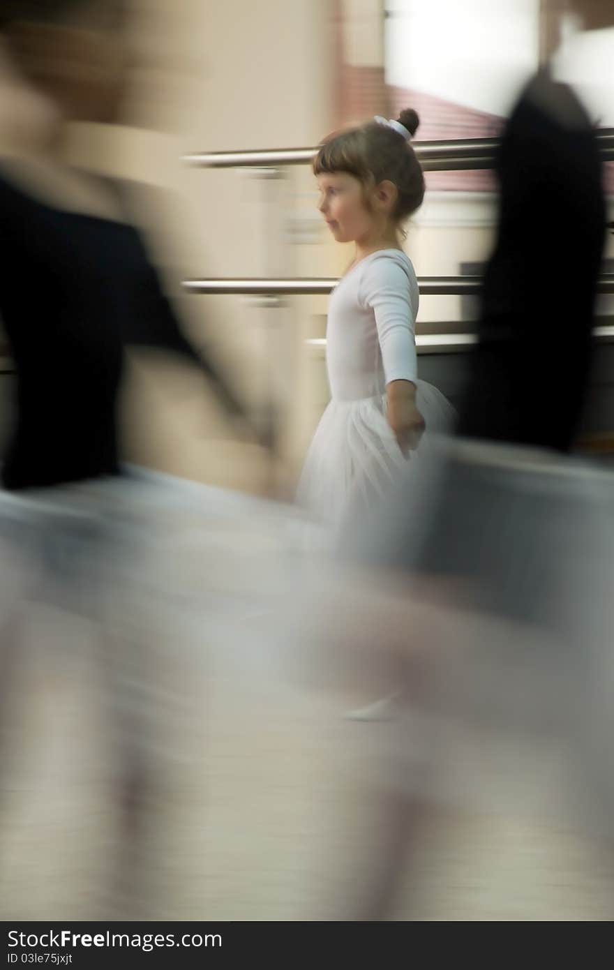 The girl in a white dress dances among children in black clothes. The girl in a white dress dances among children in black clothes