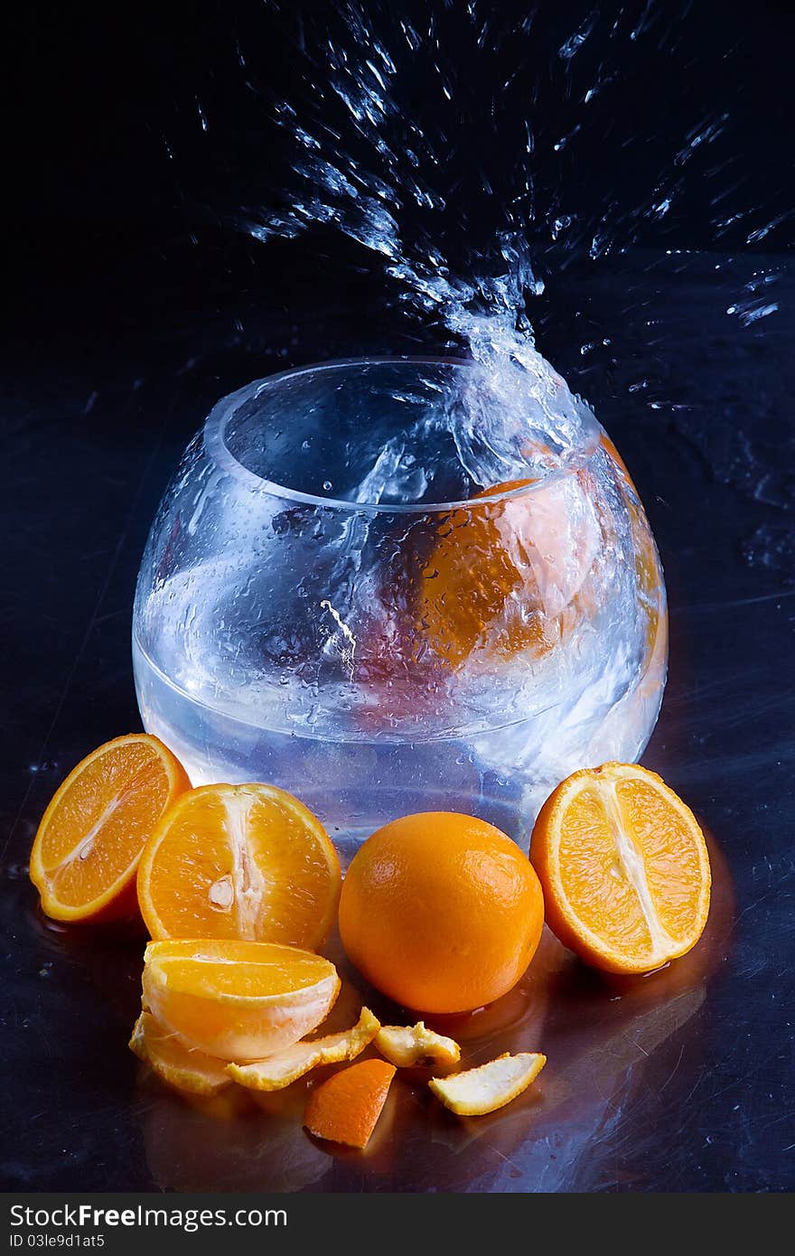 Juicy oranges with bowl of water