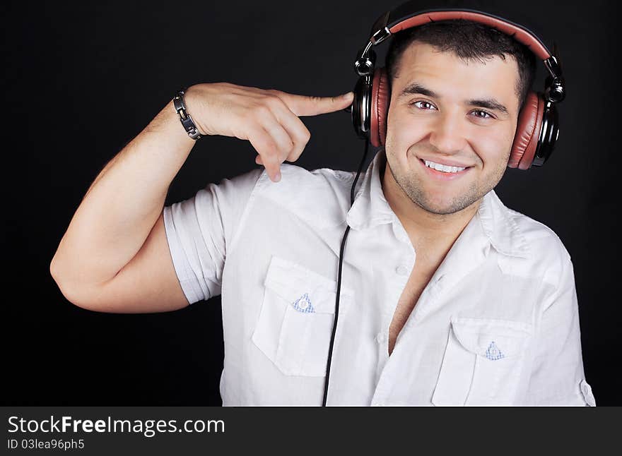 Handsome man enjoying music on headphones