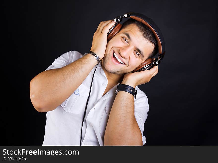 Handsome man enjoying music on headphones. Handsome man enjoying music on headphones