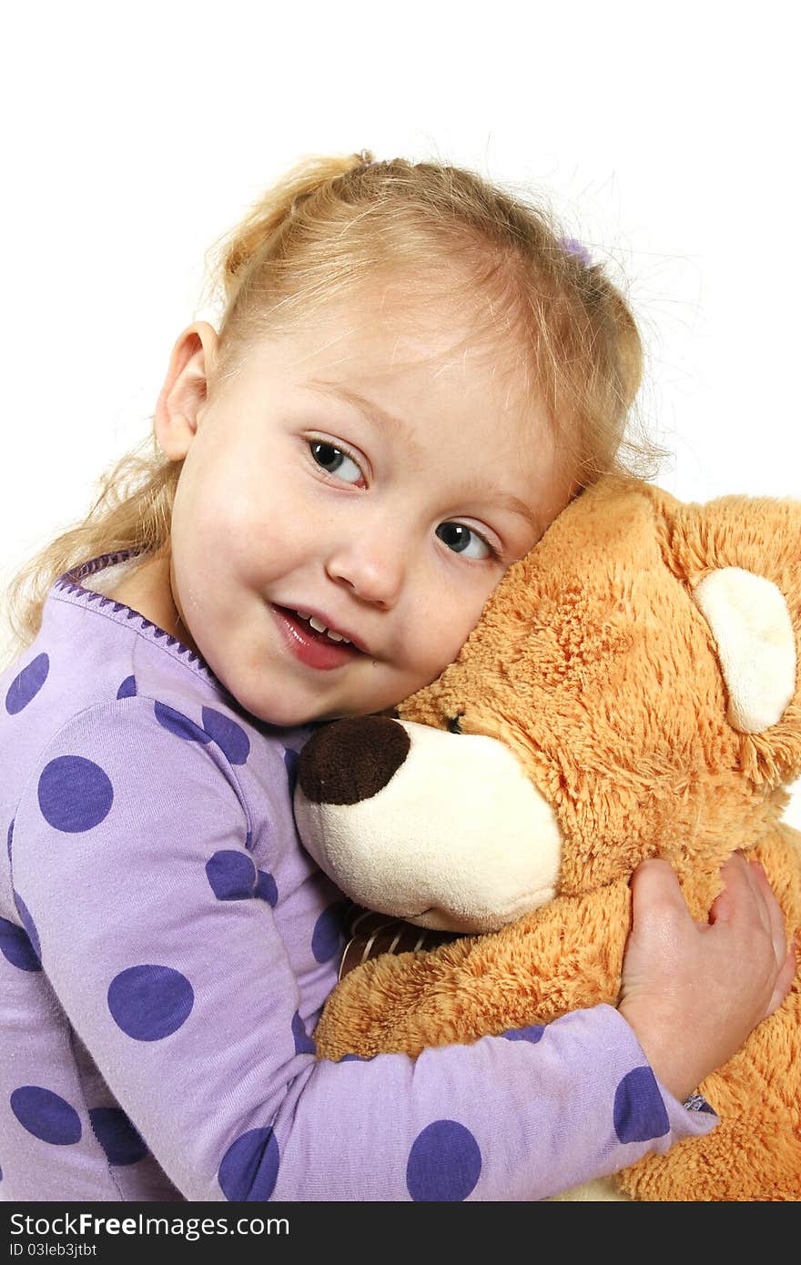 Little girl hugging a teddy bear