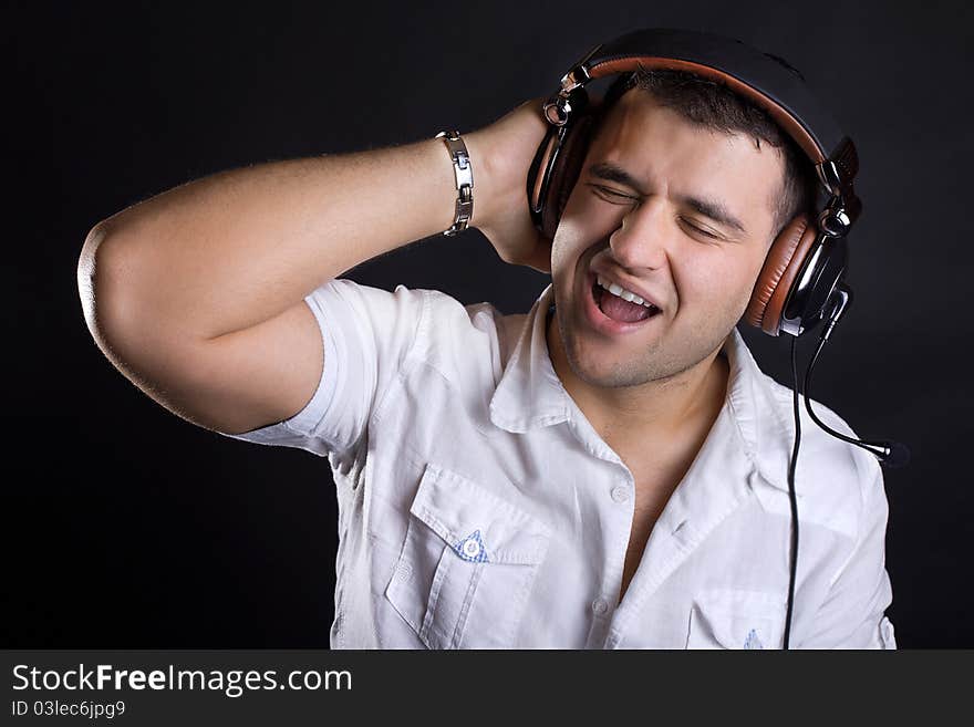 Handsome man enjoying music on headphones. Handsome man enjoying music on headphones