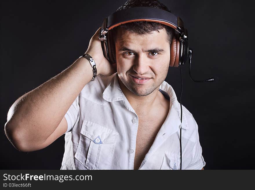 Handsome man enjoying music on headphones. Handsome man enjoying music on headphones