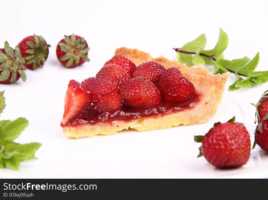 Piece of Strawberry Tart decorated with strawberries and mint