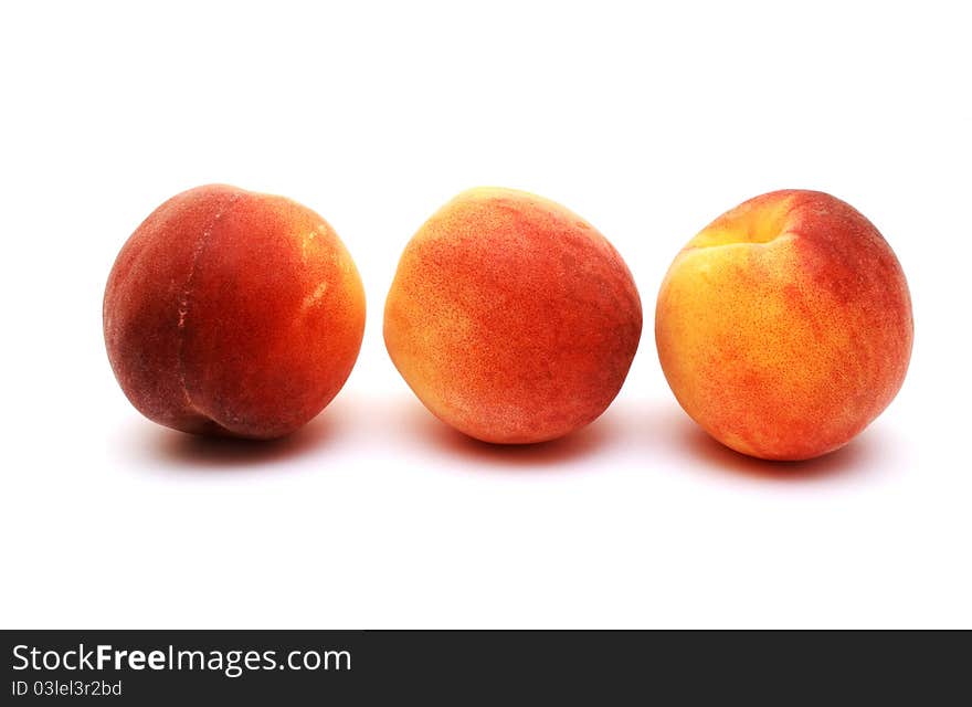 Foto of three peaches placed on white background