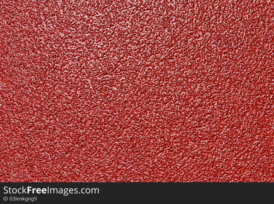 Red sheet of sand paper as background