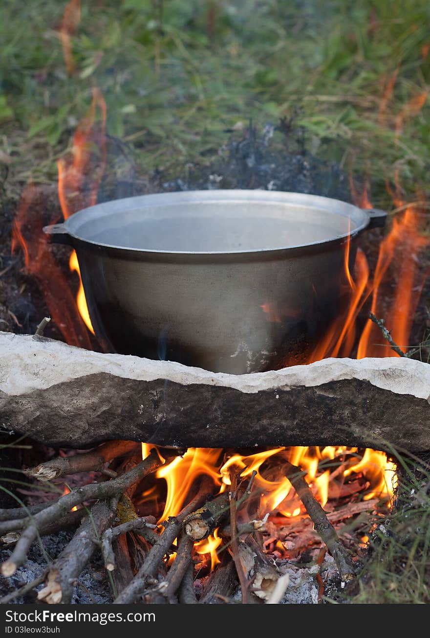 Preparing touristy food on campfire in wild camping.