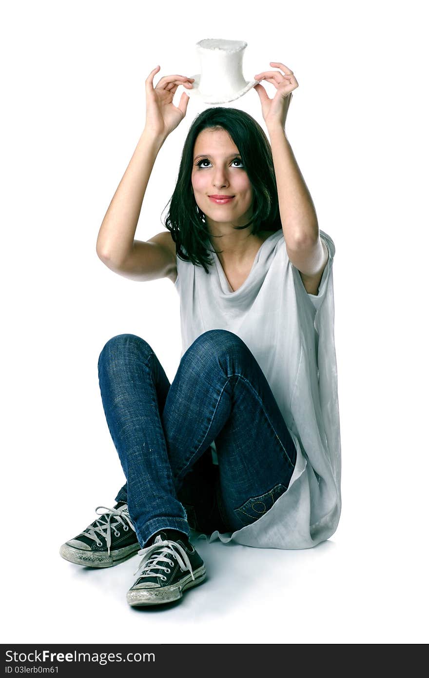 Portrait of a happy smiling young good looking girl with hat on white background