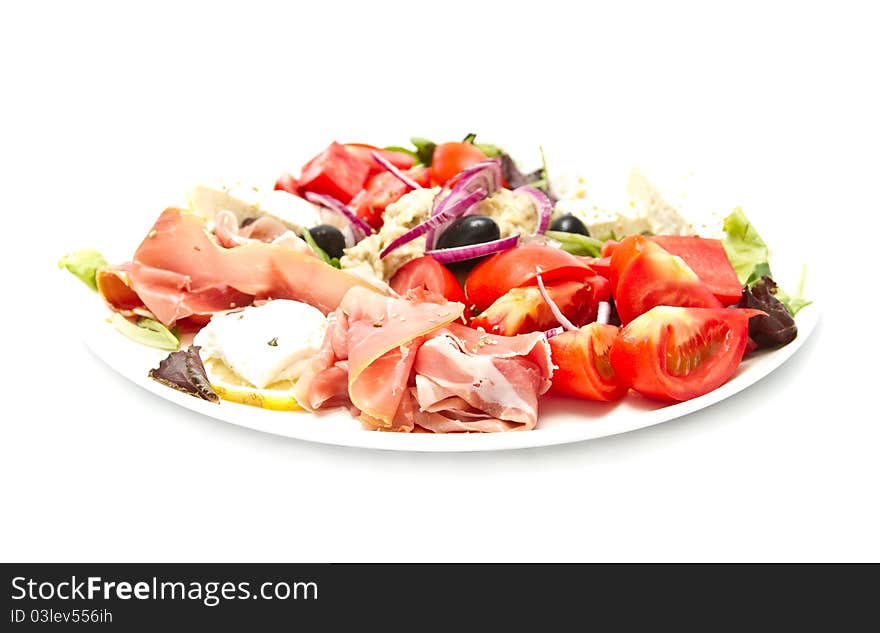 Appetizer of mixed meat, vegetables and cheese (shallow DOF)