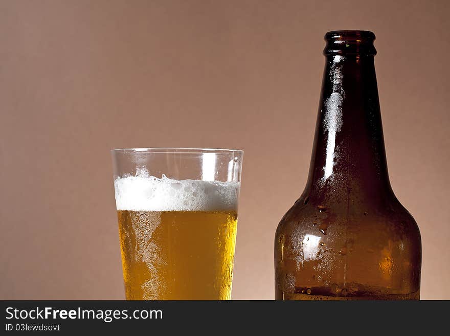 Cool bottle and glass of beer. Cool bottle and glass of beer