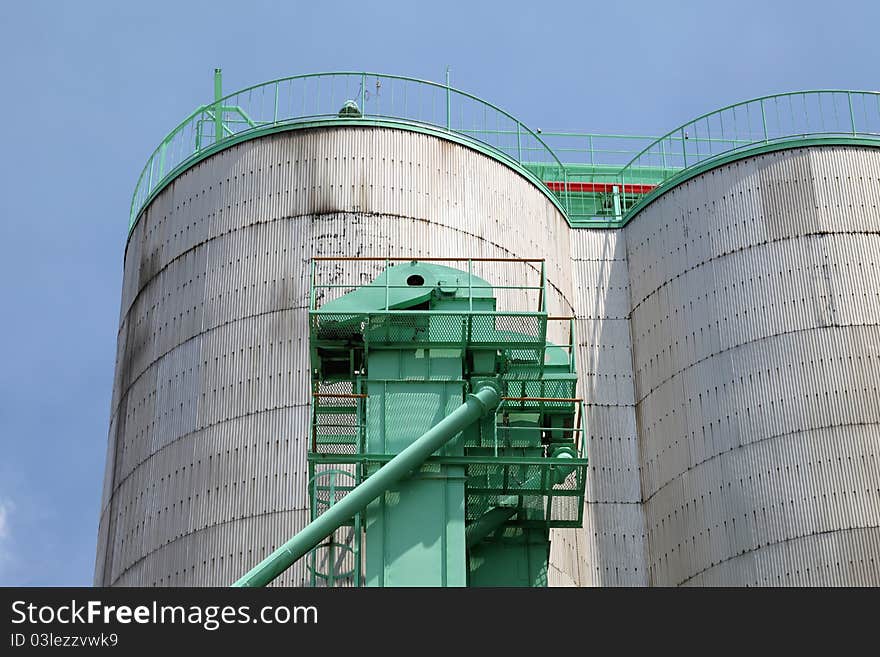 Industrial silo against the blue sky