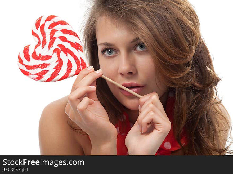 Close-up portrait of young sexy woman with heart shaped lollipop. Close-up portrait of young sexy woman with heart shaped lollipop