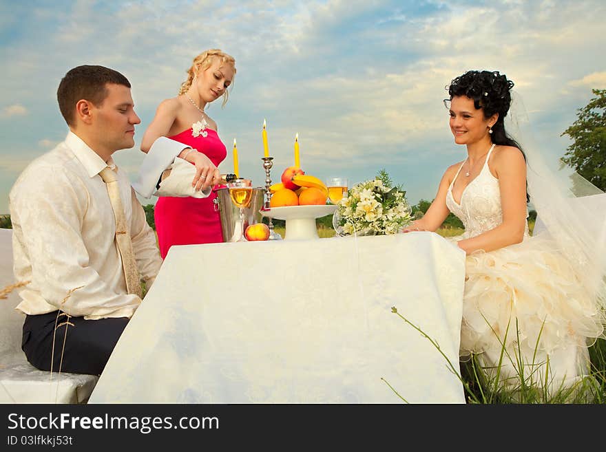 Bride and groom sitting at wedding table