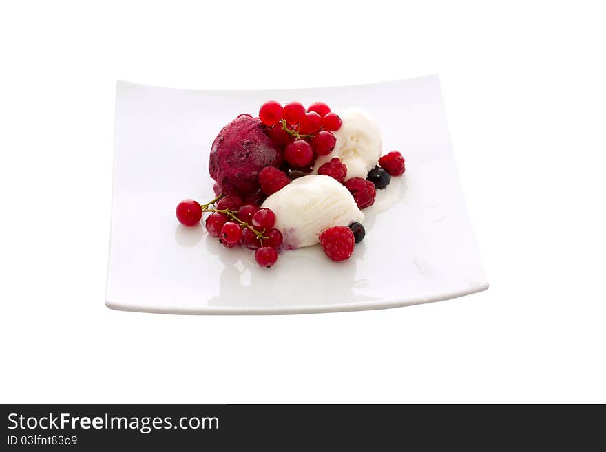 Ice cream with berries on a white plate