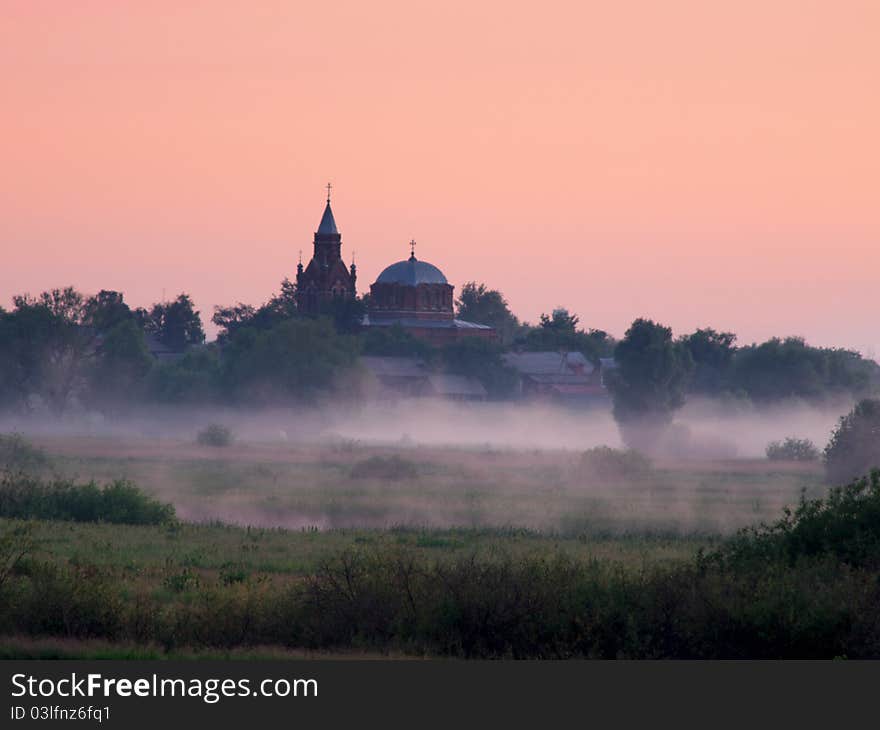 Fog over fields and orthodox church on sunrise. Fog over fields and orthodox church on sunrise.