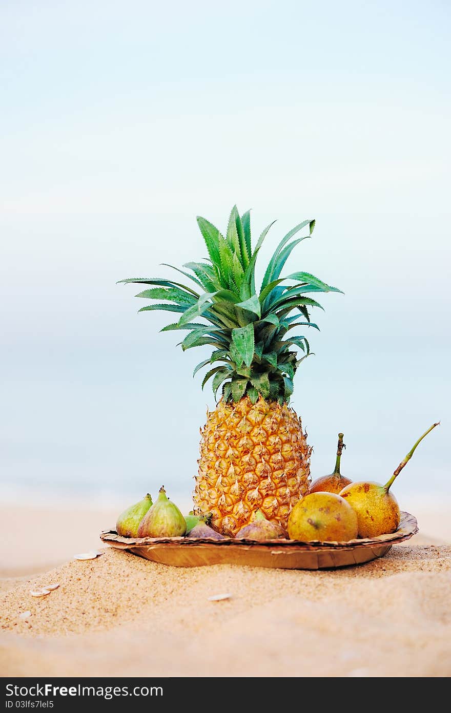 Pineapple and tropical fruit on the leaves plate. Pineapple and tropical fruit on the leaves plate