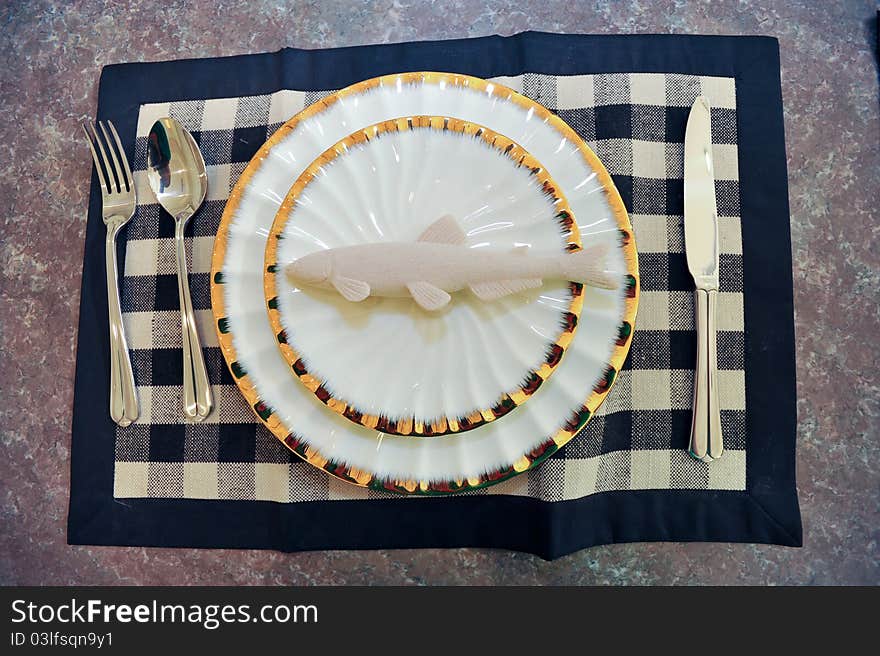 A Fish dishes model on a marble table.