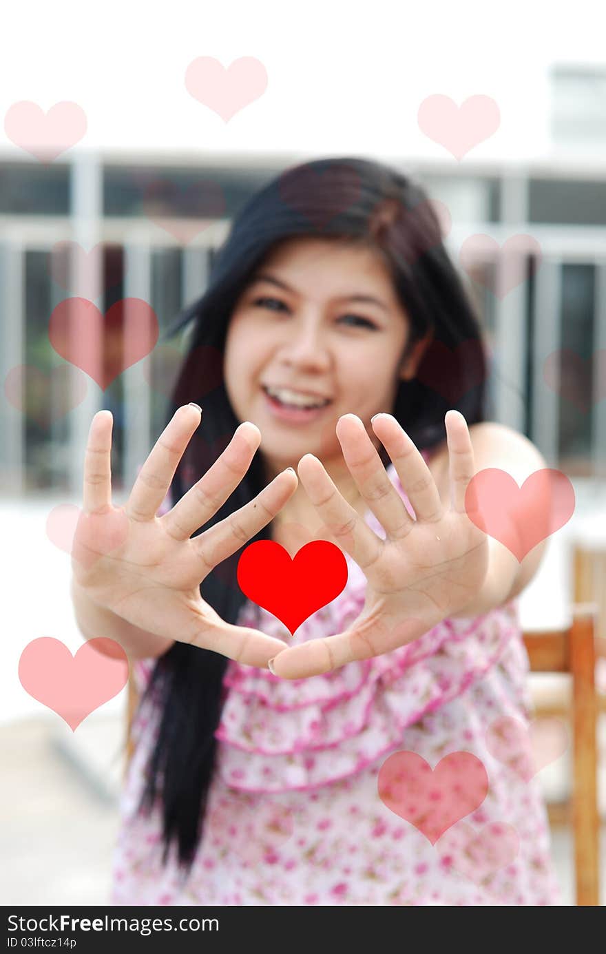 Cute young asian girl with red heart