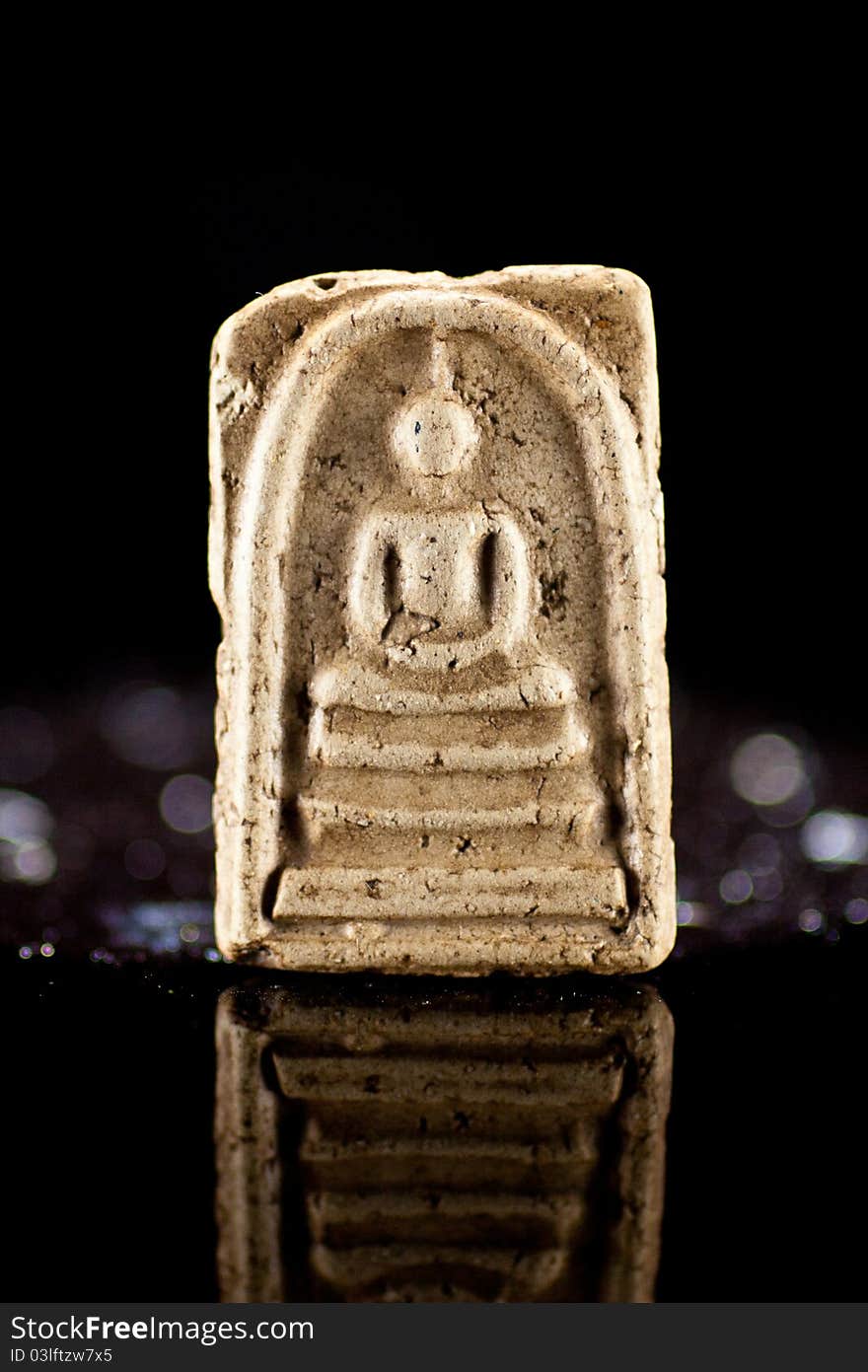 Small buddha reflect on black back ground.