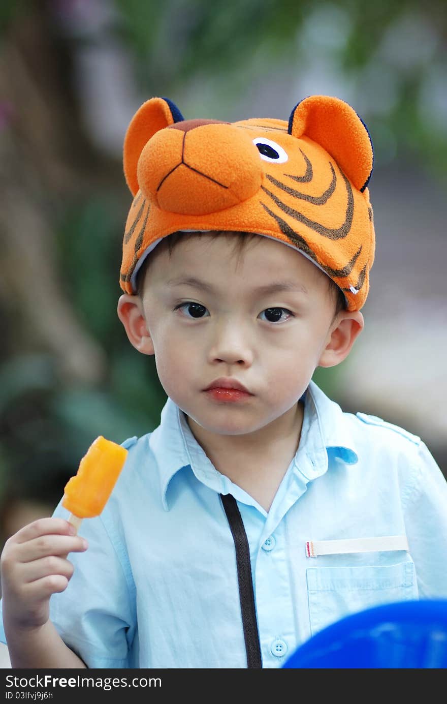 Asian young boy eating an icecream