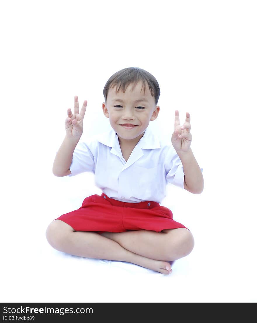 Cute young asian boy in uniform isolated on white background